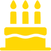 A yellow icon of a birthday cake with three lit candles on top.